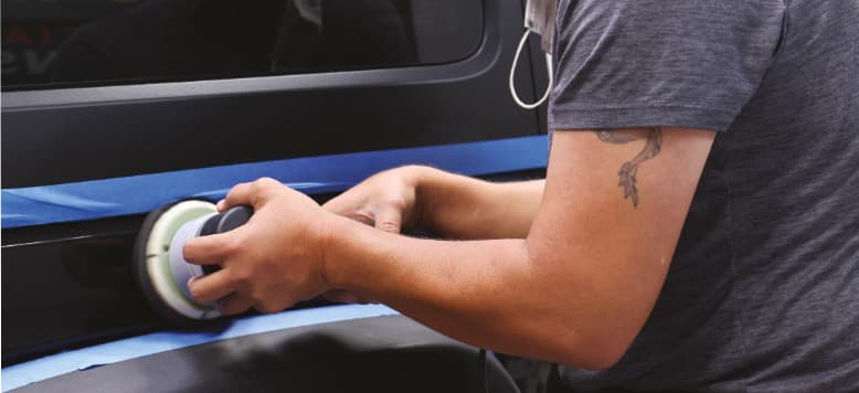 An appearance specialist performing paint correction for a finished look
