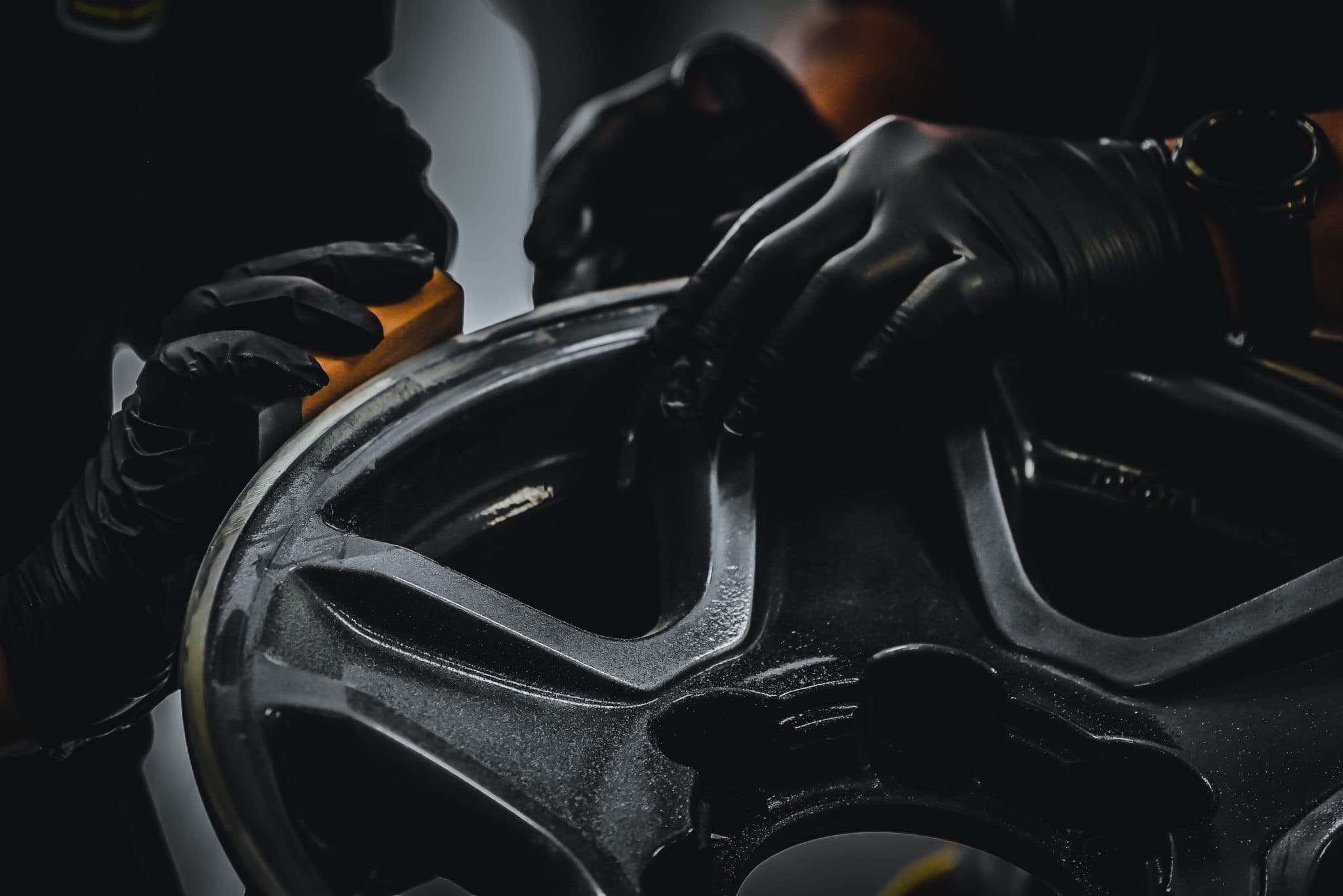 An alloy wheel being refinished during reconditioning